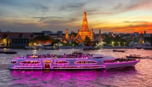 Cruzeiro noturno Grand Pearl navegando pelo rio Chao Phraya com templos iluminados ao fundo.